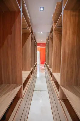 a row of wooden shelves in a closet at Appartement XXL résidence privée piscine Dar Dmana PALMERAIE in Marrakech