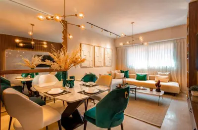 a living room with a table and green chairs at Suite Ultra Deluxe, Babylone, Ultra Confort, Hyper-Centre, Marrakesh in Marrakech