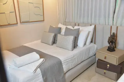 a bedroom with a bed with white sheets and pillows at Suite Ultra Deluxe, Babylone, Ultra Confort, Hyper-Centre, Marrakesh in Marrakech