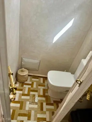 a bathroom with a white toilet in a room at Riad MONA Marrakech Kasbah Médina in Marrakech