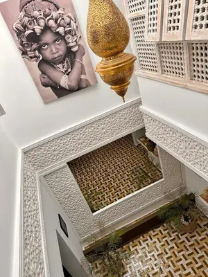 an overhead view of a stairway with a large vase at Riad MONA Marrakech Kasbah Médina in Marrakech