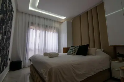a bedroom with a large bed with a window at Hivernage 50 in Marrakech