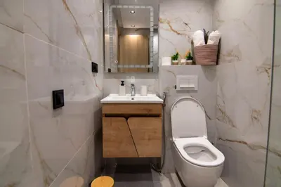 a bathroom with a toilet and a sink and a mirror at Hivernage 50 in Marrakech