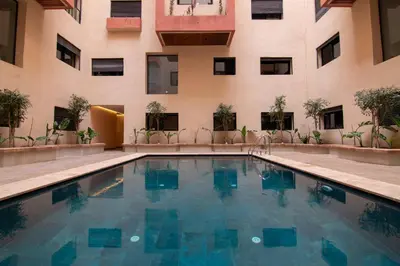 a swimming pool in front of a building at Hivernage 50 in Marrakech
