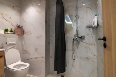 a bathroom with a shower with a toilet and a sink at Hivernage 50 in Marrakech