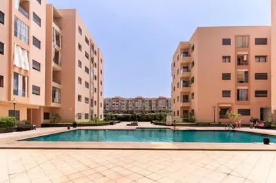 a swimming pool in the middle of two buildings at Beautiful accommodation with 2 pools & fast WiFi in Marrakech