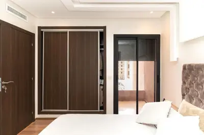a bedroom with a bed and sliding glass doors at Beautiful accommodation with 2 pools & fast WiFi in Marrakech