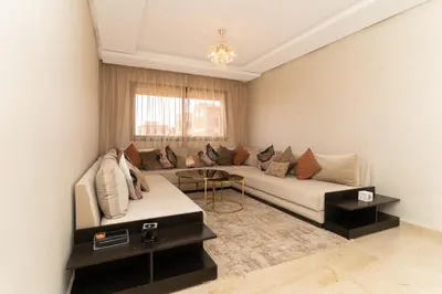 a living room with a couch and a table at Beautiful accommodation with 2 pools & fast WiFi in Marrakech