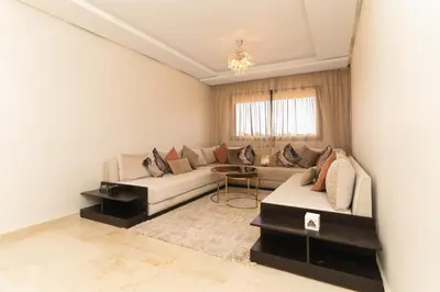 a living room with a couch and a table at Beautiful accommodation with 2 pools & fast WiFi in Marrakech