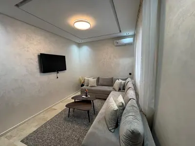 a living room with a couch and a flat screen tv at Studio Jasmine in Marrakech