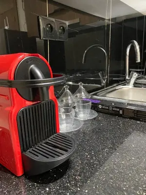 a red appliance sitting on a kitchen counter next to a sink at Studio Jasmine in Marrakech