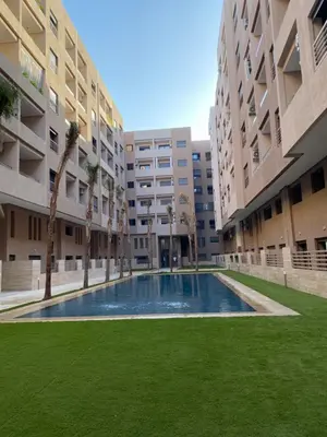 an empty courtyard of an apartment building with a swimming pool at Studio Jasmine in Marrakech