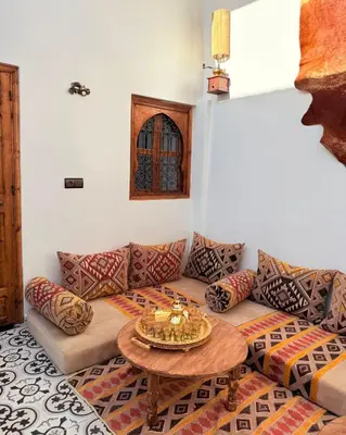 a living room with a couch and a table at Dar Skouri in Marrakech