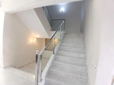 a staircase in a house with white walls and concrete stairs at Villa Zohra in Marrakech