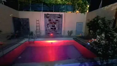 a pool with red lights in a yard at night at Villa Zohra in Marrakech