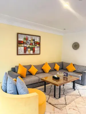 a living room with a couch and a table at Villa Premium Marrakech in Marrakech