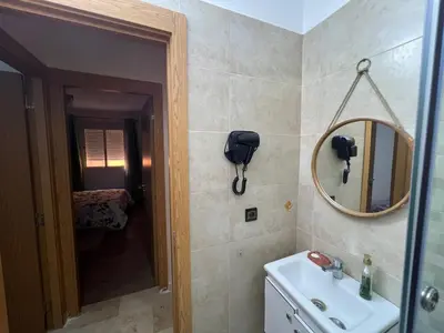 a bathroom with a sink and a mirror at NS 53 by KMREI Properties in Marrakech