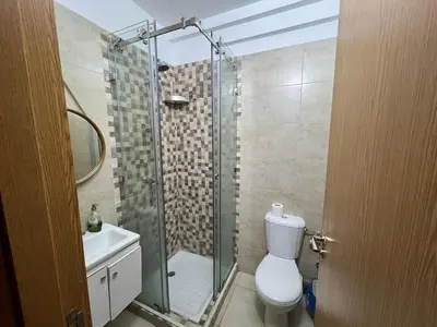 a bathroom with a shower and a toilet and a sink at NS 53 by KMREI Properties in Marrakech