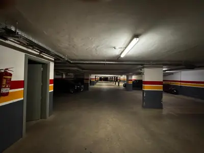 an empty parking garage with a long hallway with cars at Garden level & pool, cozy apartment queen size bed in Marrakech