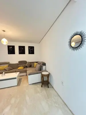 a living room with a couch and a mirror at Said in Marrakech
