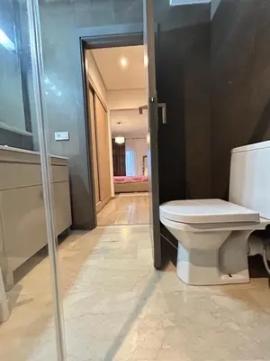 a bathroom with a toilet and a glass door at Said in Marrakech
