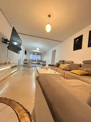 a living room with couches and a flat screen tv at Said in Marrakech