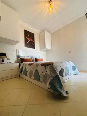 a living room with a couch in a room at Joyau Moderne Appartement in Marrakech