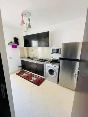 a kitchen with a refrigerator and a washing machine at Joyau Moderne Appartement in Marrakech