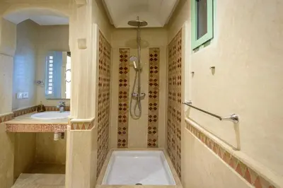 a bathroom with a shower and a sink at Appartement Confort - Hivernage - Piscine in Marrakech