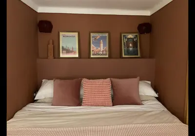 a bedroom with a bed with four pictures on the wall at Riad Al Muhandiz Peaceful Duplex Suites near Jemaa El Fna in Marrakech