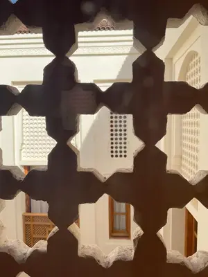 a view of a building through a window at Riad Al Muhandiz Peaceful Duplex Suites near Jemaa El Fna in Marrakech
