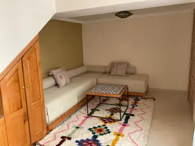 a small room with a couch and a table at Riad Al Muhandiz Peaceful Duplex Suites near Jemaa El Fna in Marrakech
