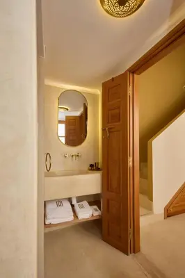 a bathroom with a sink and a mirror at Riad Al Muhandiz Peaceful Duplex Suites near Jemaa El Fna in Marrakech
