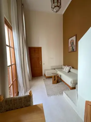 a living room with a couch and a table at Riad Al Muhandiz Peaceful Duplex Suites near Jemaa El Fna in Marrakech