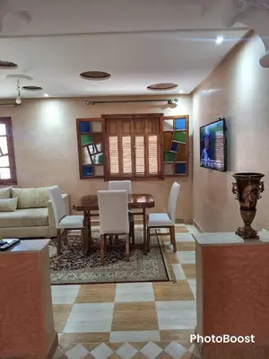 a living room with a table and chairs and a couch at Oasis Menara in Marrakech