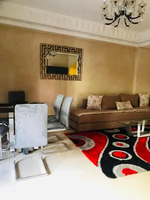 a living room with a couch and a mirror at Appartement Ihssane Plaza Kech in Marrakech