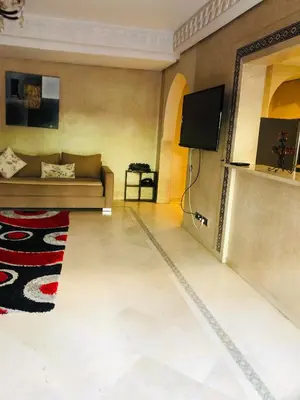 a living room with a couch and a flat screen tv at Appartement Ihssane Plaza Kech in Marrakech