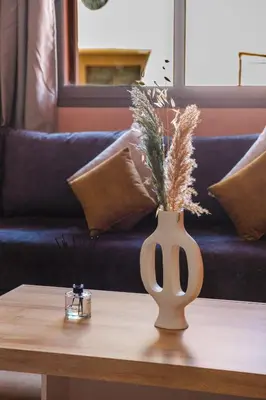 a table with a vase on top of a couch at apartment gilez in Marrakech