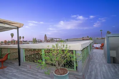 a balcony of a house with a tree on it at Dar JOMANA in Marrakech