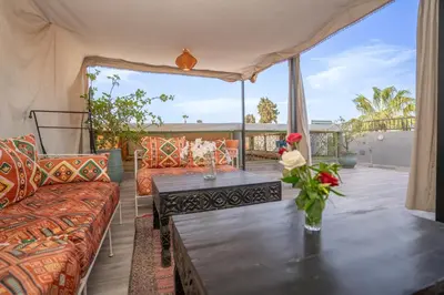 a living room with a table and a couch at Dar JOMANA in Marrakech