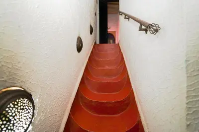 a stairway leading into a room with red stairs at Dar JOMANA in Marrakech