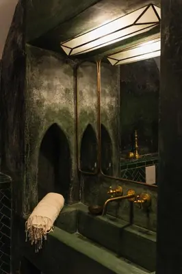 a bathroom with a sink and a mirror at Riad Mint - Luxury Oasis in the Medina with Pool in Marrakech