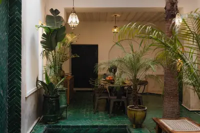 a dining room with potted plants and a table at Riad Mint - Luxury Oasis in the Medina with Pool in Marrakech
