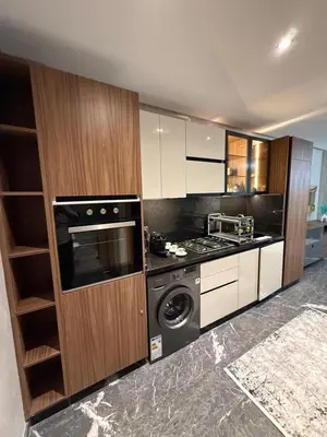 a kitchen with a stove and a washing machine at Elite studio 17 in Marrakech