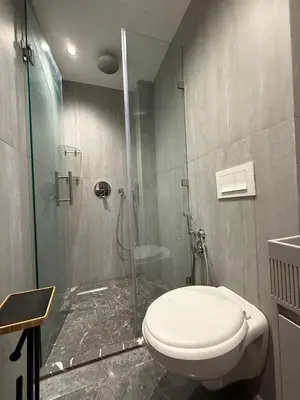 a bathroom with a toilet and a glass shower at Elite studio 17 in Marrakech