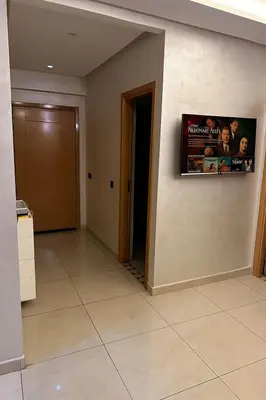 a room with a television on a wall at Appartement familial moderne et cosy in Marrakech