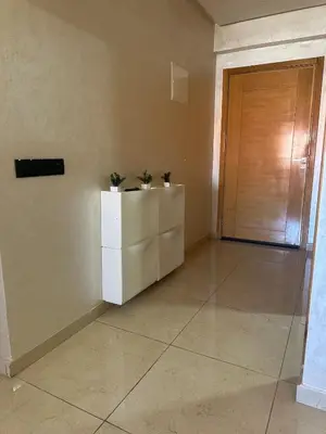 a room with a door and two plants on a dresser at Appartement familial moderne et cosy in Marrakech