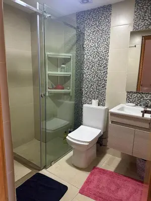 a bathroom with a shower and a toilet and a sink at Appartement familial moderne et cosy in Marrakech