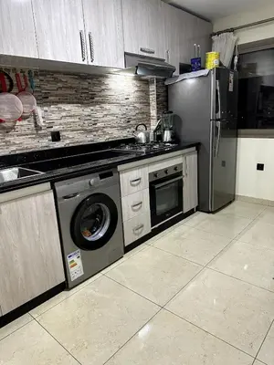 a kitchen with a stainless steel refrigerator and a dishwasher at Appartement familial moderne et cosy in Marrakech