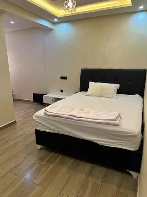 a bedroom with a large bed in a room at Appartement familial moderne et cosy in Marrakech